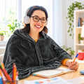 Woman wearing the USB heated wearable blanket at her desk