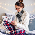 Woman wearing the USB heated scarf in dark grey at home